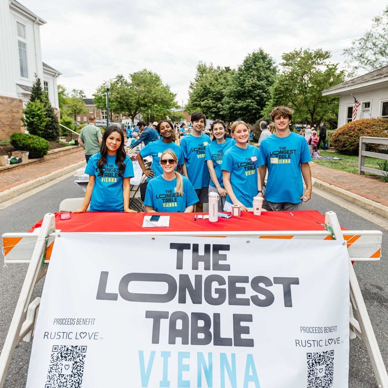 Neighbors gathered along the long table on Mill Street